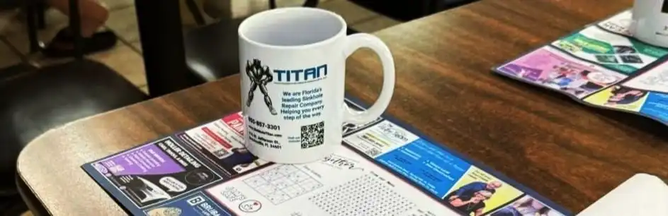 Titan Backflow Repair branded coffee mug on a café table